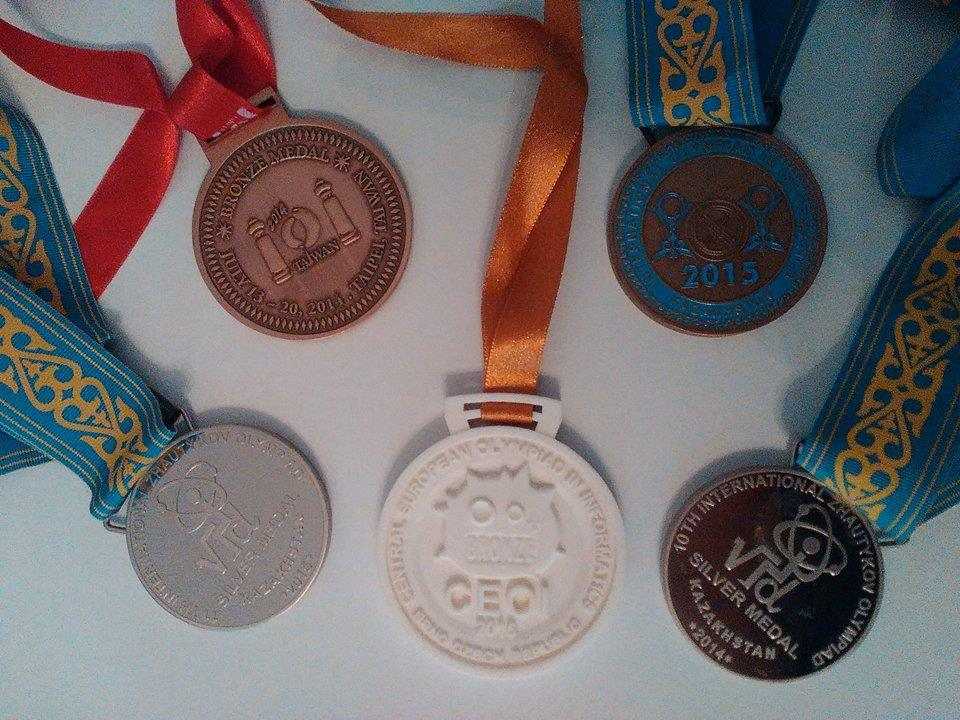 Five olympiad medals displayed on a table